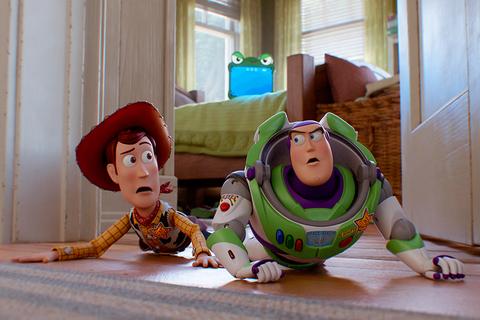Woody and Buzz Lightyear crawling on bedroom floor