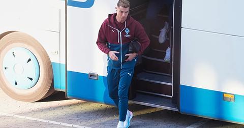 Cristiano Ronaldo stepping off team bus with bag