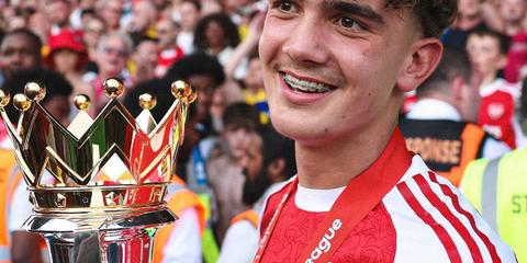 Max Dowman smiling alongside Premier League trophy