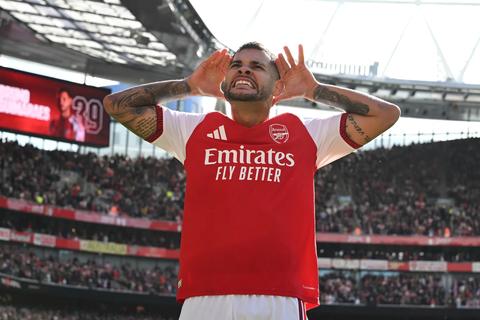 Arsenal player celebrating in front of fans