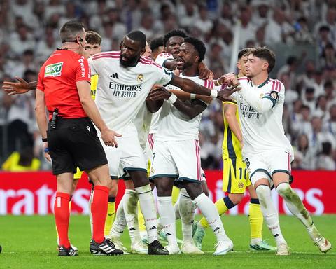 Real Madrid players arguing with referee