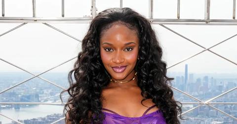 woman with curly hair in purple top