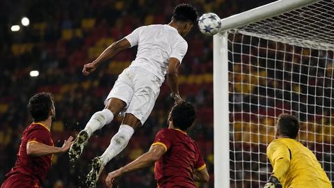 Real Madrid player scoring a header