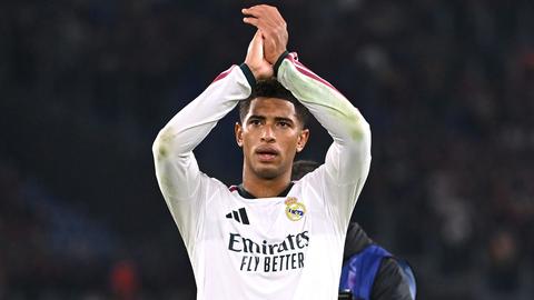 player in real madrid kit applauding