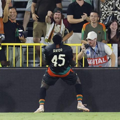 football player with name AKOR on his back facing fans