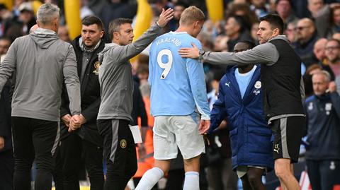 footballer named Haaland being attended by staff
