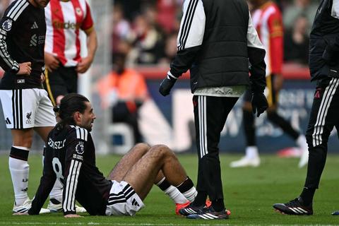 player sitting on grass in pain