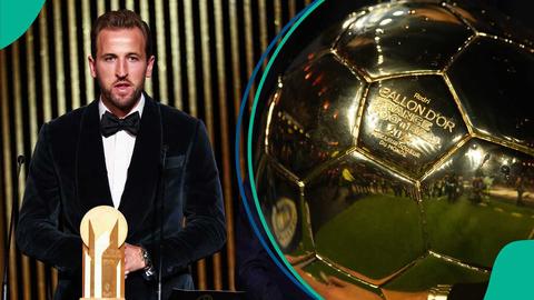 man in tuxedo holding a golden trophy