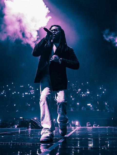 man performing on stage with a microphone