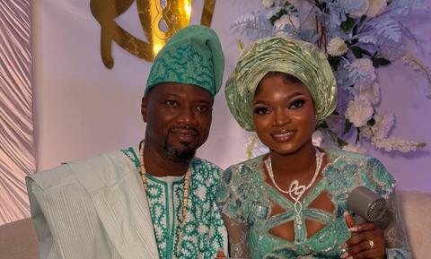 man and woman in green traditional attire