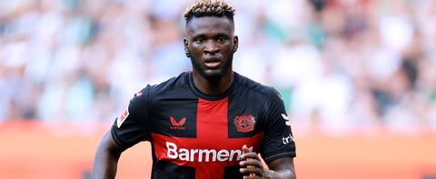 striker running in Leverkusen kit, close action shot