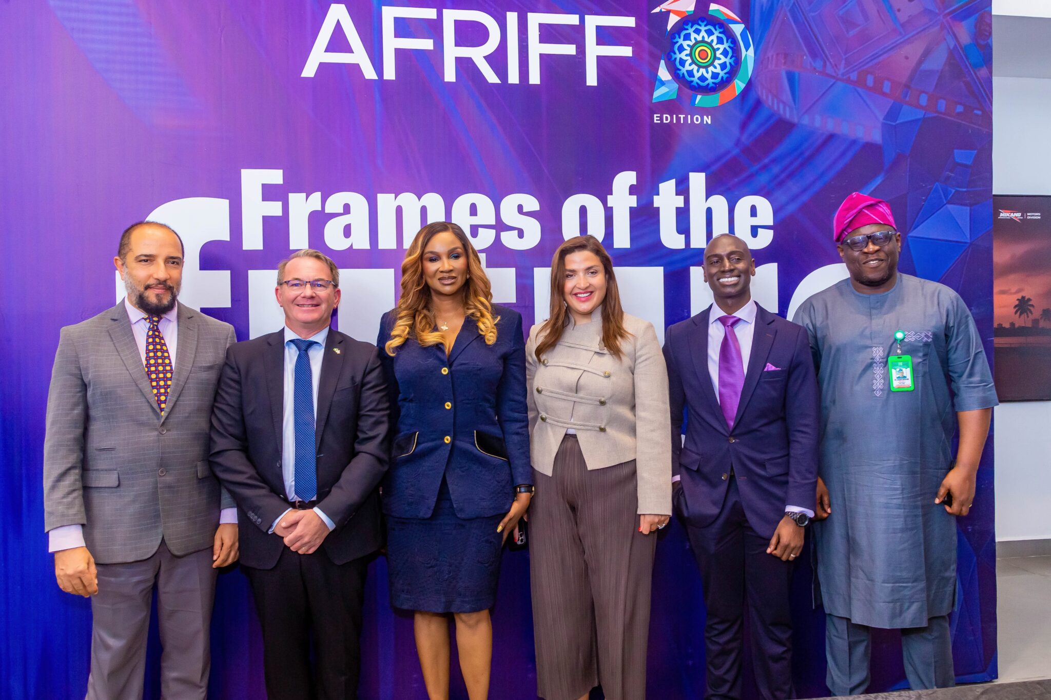 group of people posing in front of AFRIFF backdrop