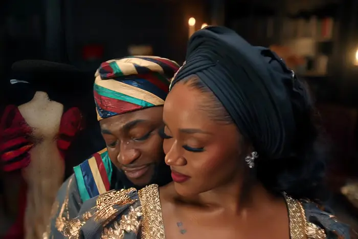 Davido and Chioma in traditional headties and gold-trimmed outfits, close and affectionate