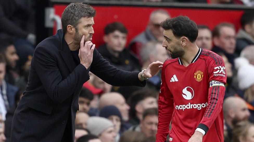 Michael Carrick instructing Bruno Fernandes during a match