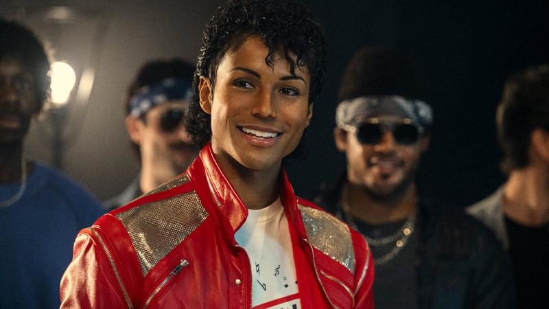 man in a red jacket surrounded by others