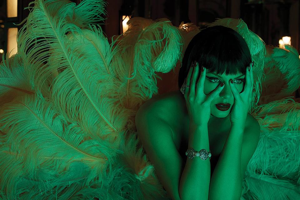 Taylor Swift styled with feathers and green lighting