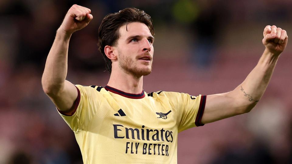 Declan Rice celebrating in yellow Arsenal away kit