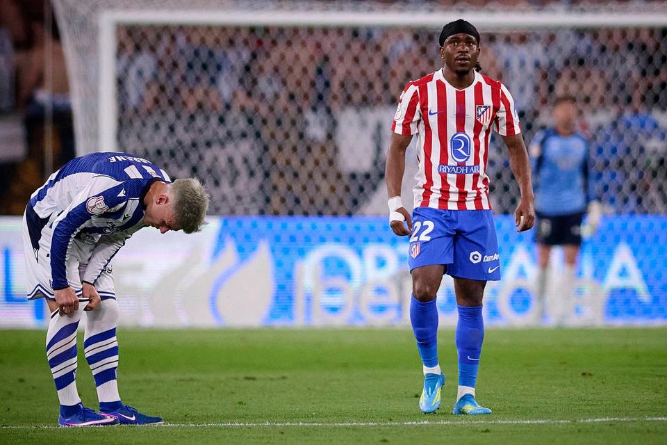 player in red and white striped kit