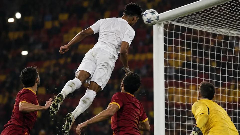 Real Madrid player scoring a header