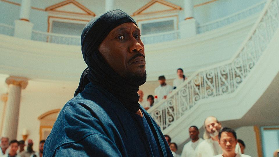 man in headwrap and blue garment