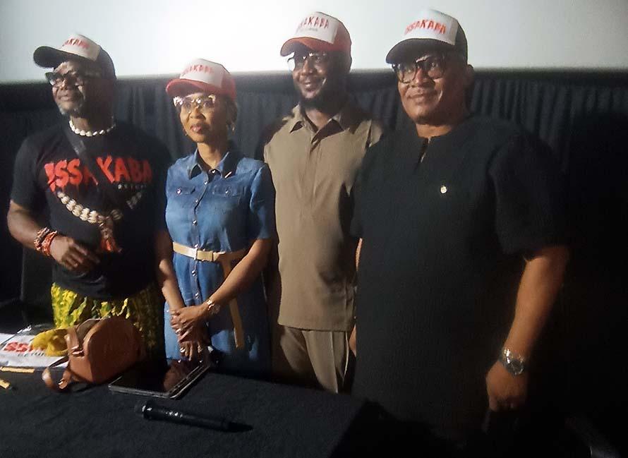 Four people wearing hats and shirts related to the film