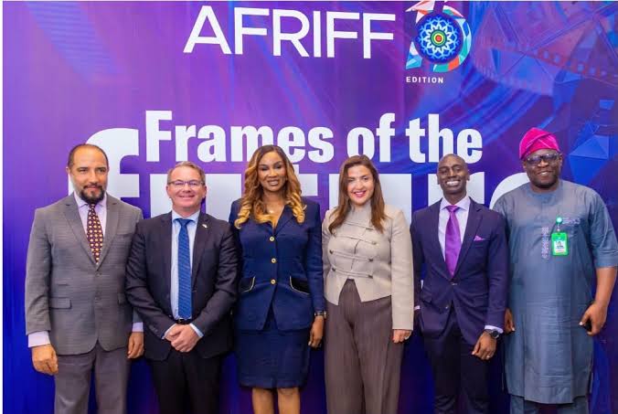 group of people posing in front of AFRIFF backdrop