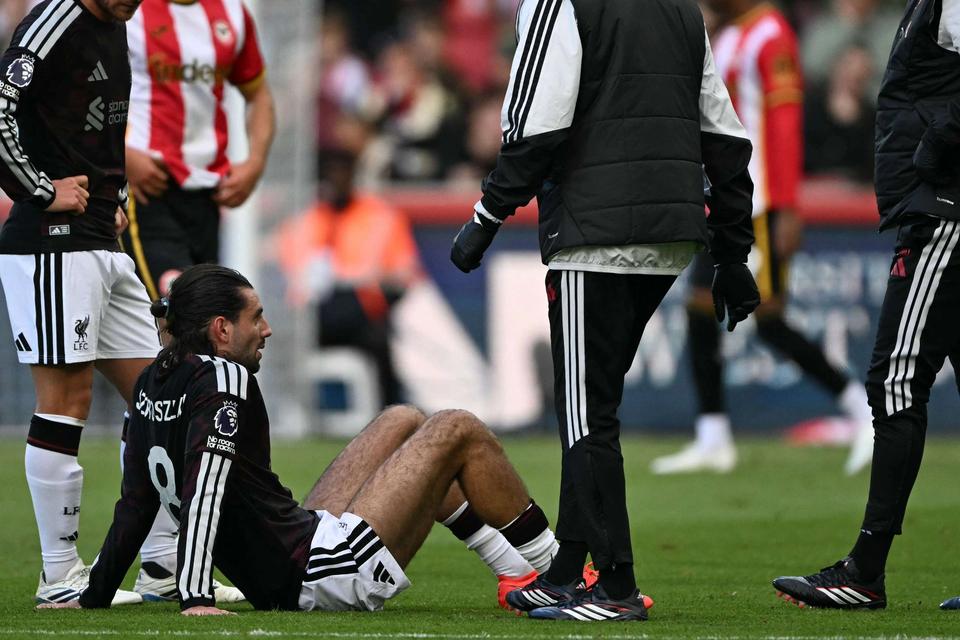 player sitting on grass in pain