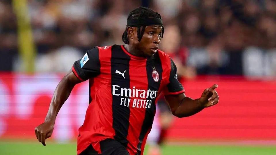 footballer in red and black kit