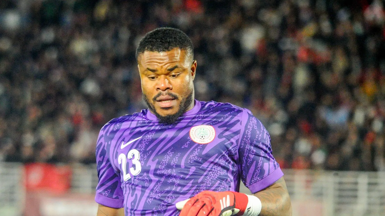 Goalkeeper Stanley Nwabali in Nigeria's purple kit, gloves in hand; directly on theme for a clean-sheet story