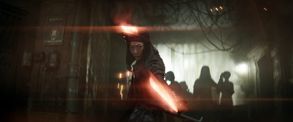 A female warrior wielding a red laser sword